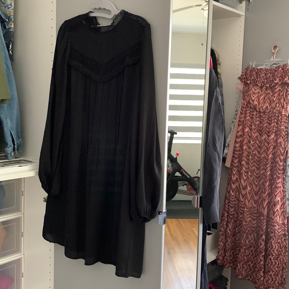 Gently worn black flowy dress. Above the knee length.